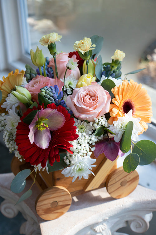 New Baby Flowers in a wooden carriage